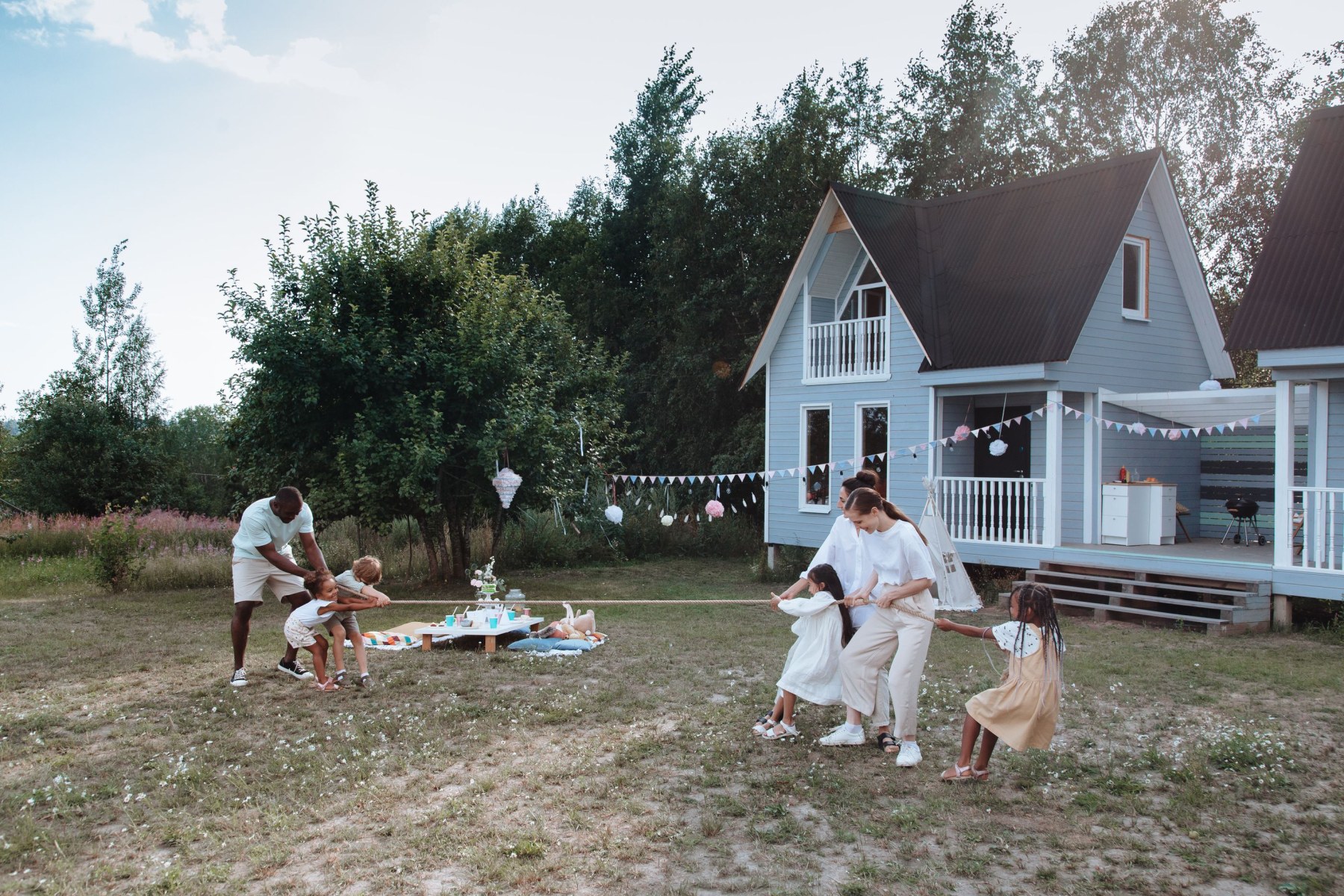 Family spending time outdoors beside their home