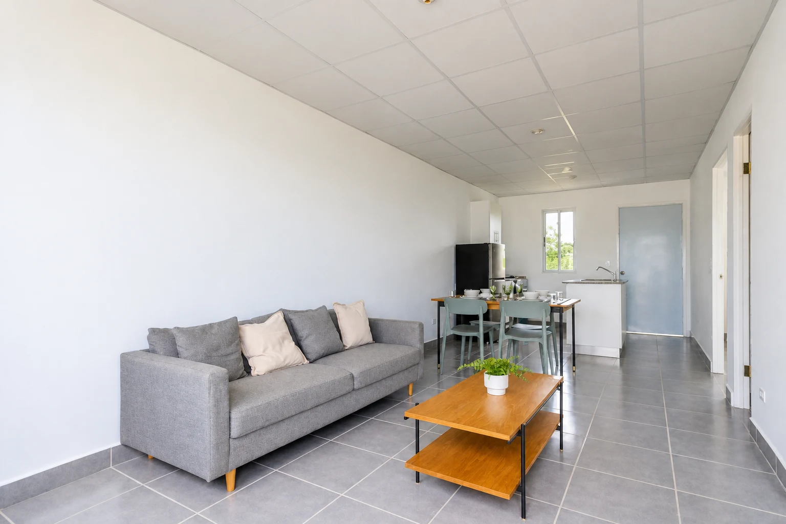 Living room, dining area and kitchen in Casaya. Photograph retouched with AI; display furniture